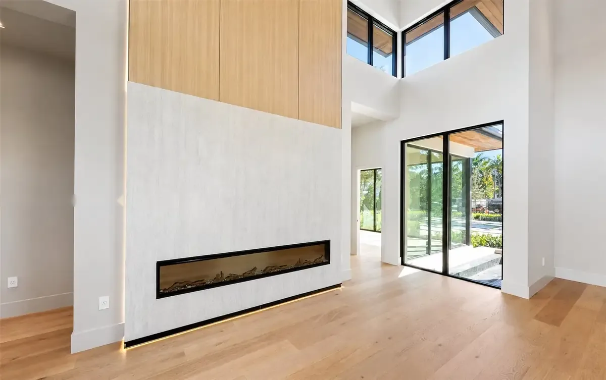 Great room with linear fireplace and full-height glass