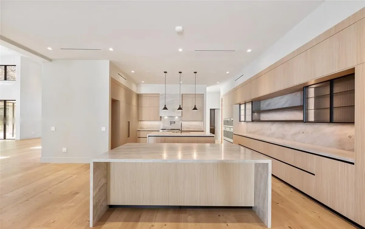 Chef's kitchen with dual Pedini islands and pendant lights