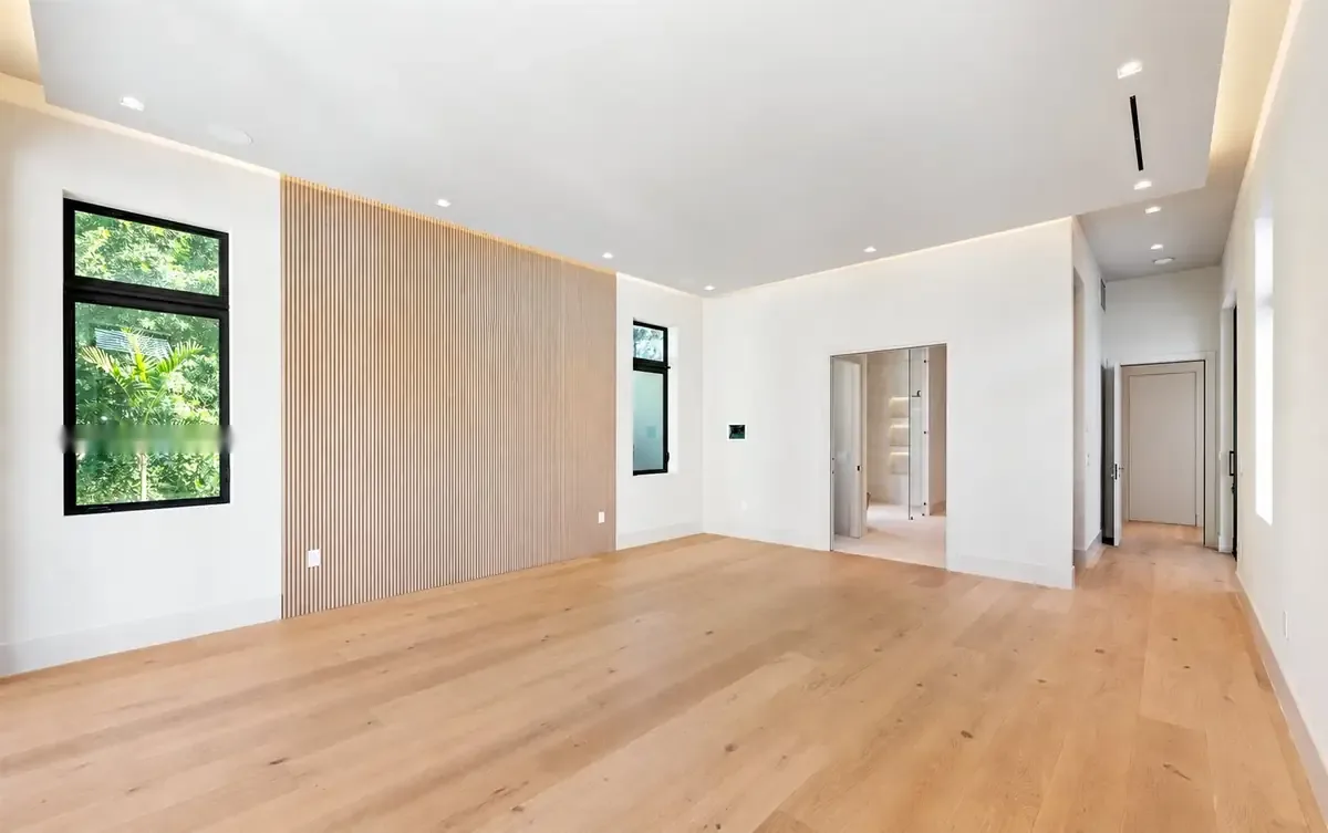 Primary bedroom opening to the landscape