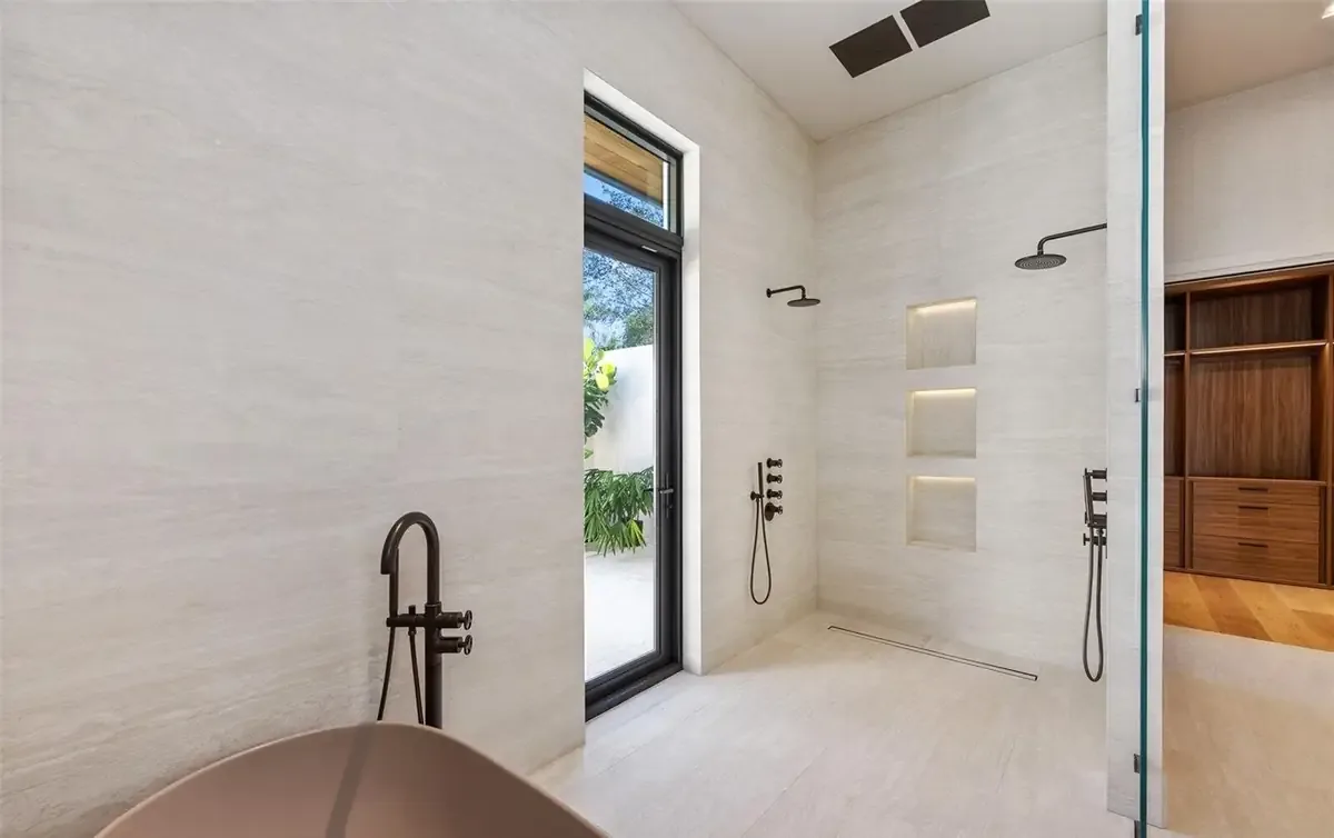 Primary bath with freestanding tub and Graff fixtures